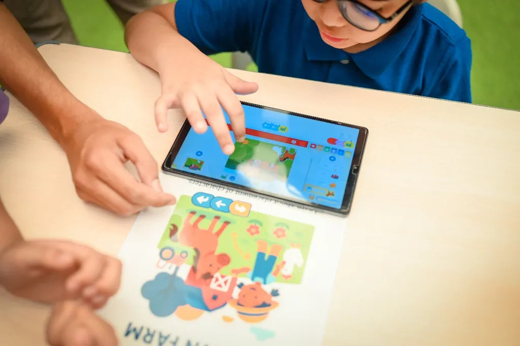 Student coding on a tablet during a tech session