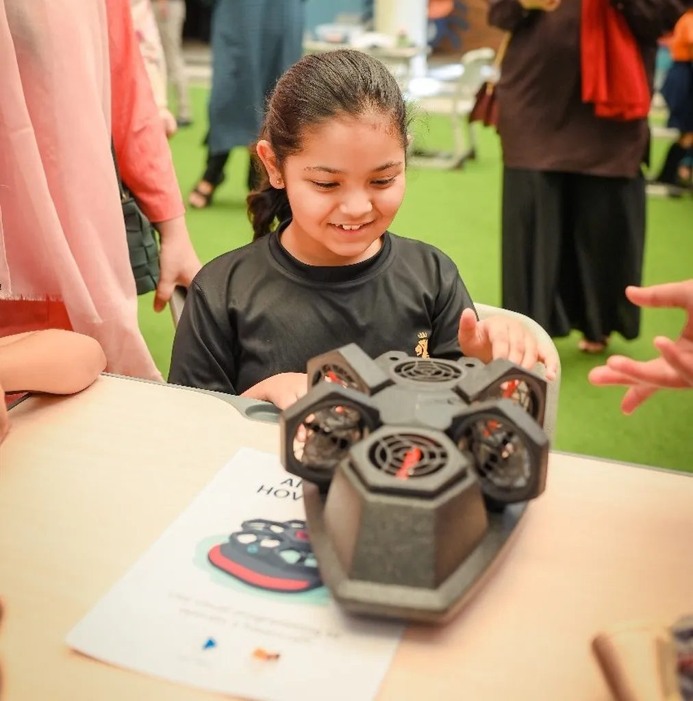 Student excited at Showcase Day presenting her drone build