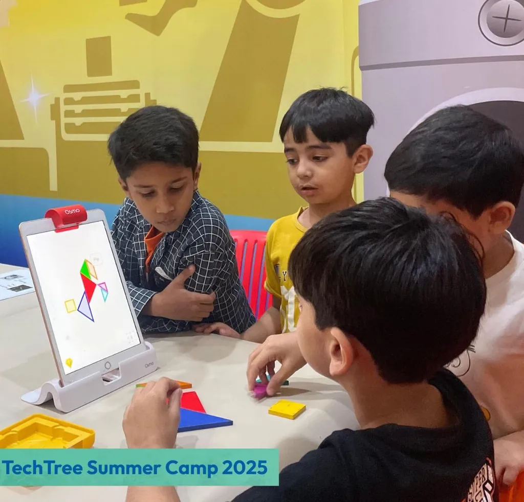 Boys collaborating on an Osmo coding puzzle